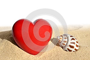 Conch shell with heart in sand
