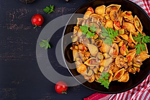 Conchiglie pasta. Italian pasta shells with mushrooms, zucchini and tomato sauce.