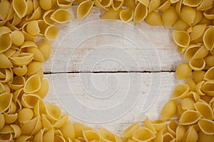 Conchiglie pasta on wooden table