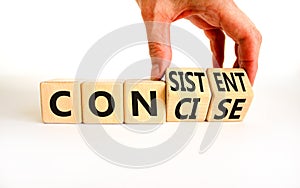 Concise or consistent symbol. Businessman turns wooden cubes and changes concept word Concise to Consistent. Beautiful white table