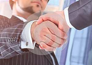 The conclusion of the transaction. of an office building. Handshake.