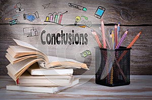 Conclusions, Business Concept. Stack of books and pencils on the wooden table.