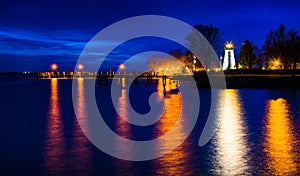 Concord Point Lighthouse and a pier at night in Havre de Grace