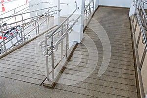Concret ramp way with stainless steel handrail with disabled sign for support wheelchair disabled people