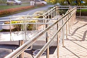 Concret ramp way with stainless steel handrail with disabled sign for support wheelchair disabled people. Health care
