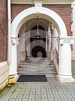 Concrete arch with stairs and doors as entrance