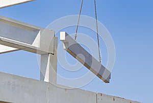 Concrete beam on crane cables in the sky