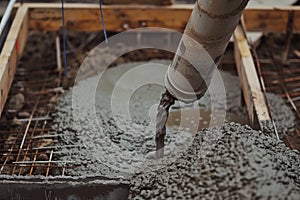 concrete being poured into formwork through a pipe