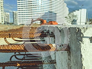 Concrete block with rusty rebar sticking out inside. fasteners for the construction of concrete high houses. blocks on the