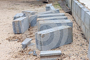 Concrete blocks in construction site of a fence.