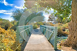 Concrete bridge with painted green barrier over a creek at Sweetwater Wetlands- Tucson, Arizona