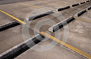 concrete bumpers,empty parking lot