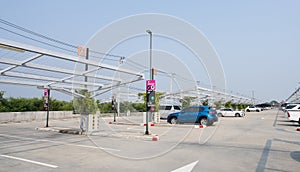 Concrete car parking lot with empty space. Private car park for customer service. Parking zone on a sunny day. Outdoor parking lot