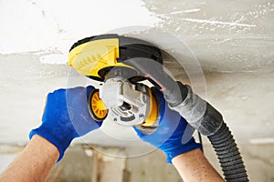 Concrete ceiling surface grinding by angle grinder machine
