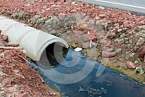 Concrete circular run-off pipe discharging water. sewage pipe polluting the river. Sewage or domestic wastewater or municipal wast photo
