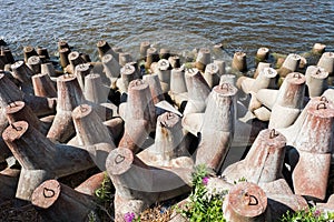 Concrete coastal fortifications on the sea. Tetrapods