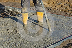 Concrete is compacted by builder with concrete vibrator