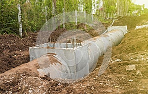 Concrete culvert drainage water row on a Construction Site .Concrete pipe stacked sewage water system aligned on site.