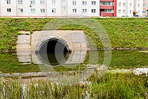 Concrete culvert pipe hole system draining sewage water near the