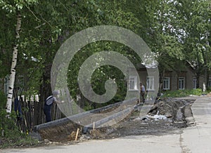 Concrete curb installation. String line level guide is stretched parallel to the line of course. Sidewalk pavement renewal. Road i