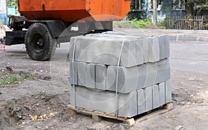 Concrete curbs on pallet, construction of road