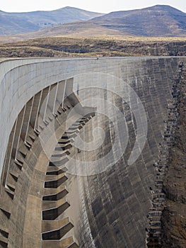 Concrete dam wall and overflow of impressive Katse Dam hydroelectric power plant in Lesotho, Africa