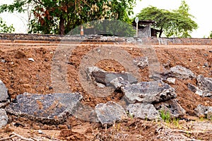 Concrete demolition debris pile on the mound by the roadside.