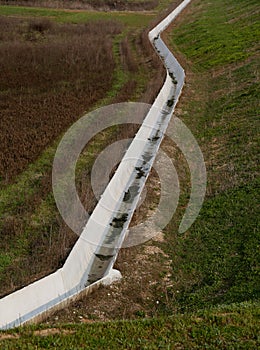 Concrete ditch on the field to transport water for irrigation du