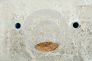 Concrete drain hose looks like a smiling man.
