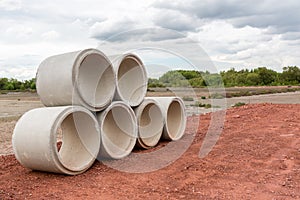 Concrete Drainage Pipe on a Construction Site.  Concrete drainage pipes stacked for construction. Concrete drainage tube on constr