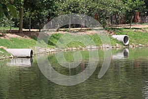 Concrete drainage pipes are installed above the surface of a lake to prevent the excessive filling of rainwater in the lake