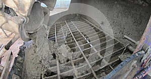 concrete falls from the concrete mixer onto the grate