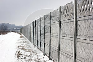 Concrete fence. Winter.