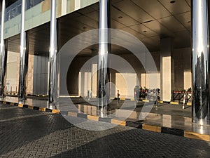Concrete filled stainless steel finished tubular columns in an entrance of an Big shopping mall construction exterior finishes for
