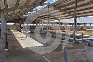 Concrete floor with building under construction. Concrete base of the floor. Construction of the hangar