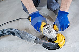 Concrete floor surface grinding by angle grinder machine