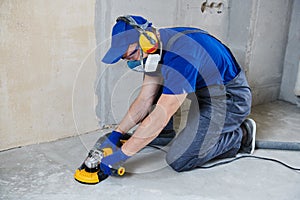 Concrete floor surface grinding by angle grinder machine photo
