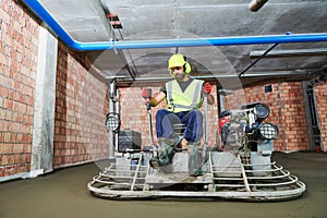 Concrete flooring. using ride-on power trowelling machine for surface floating