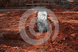 Concrete footer being poured