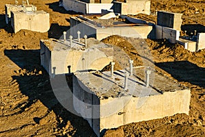 Concrete footings with anchor bolts.