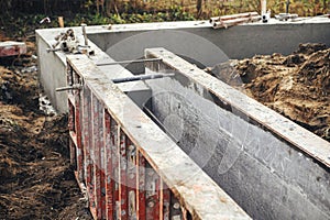 Concrete foundation with reinforcement and metal slab. Formwork for foundation. Construction site, process of house building. New