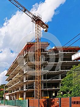 Concrete frame structure of a new multi-story apartment building and crane, vertical