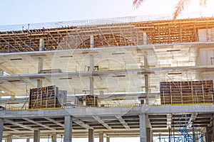 Concrete frame of tall apartment building under construction in a city