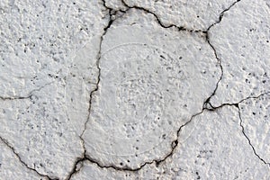 Concrete grey wall with cracks