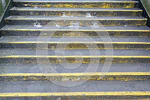 Concrete grey and yellow steps. Urban dirty grubby background or concept.