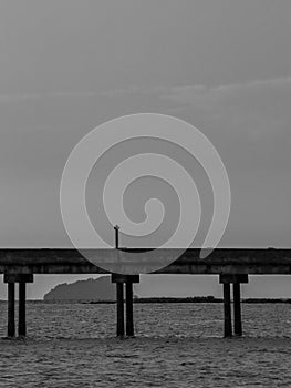 a concrete jetty in black and white