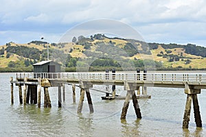 Concrete jetty in muddy harbor