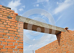 Concrete lintel. Window or door concrete lintel on brick unfinished house construction. photo