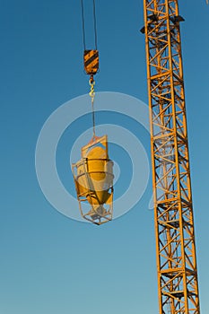 Concrete machine for spreading cement hoisted at building site