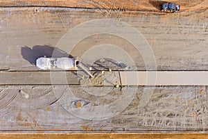 Concrete mix truck with pouring cement during to residential sidewalk street